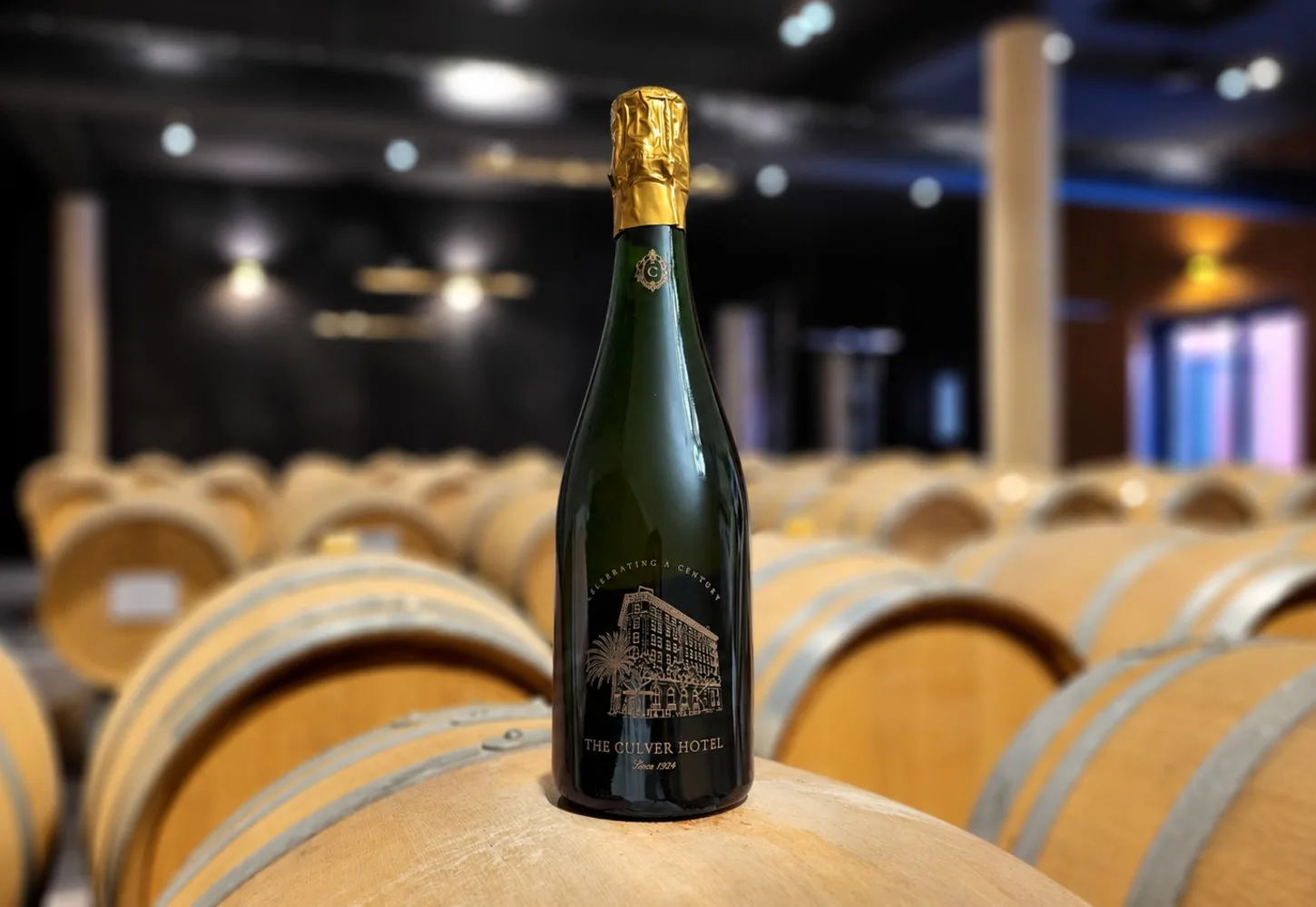 The finished engraved Brut Assemblage for The Culver Hotel, standing on a barrel in the Tribaut cellar